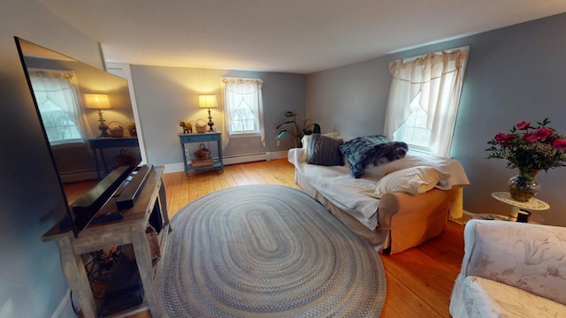 living room with light hardwood / wood-style floors and baseboard heating
