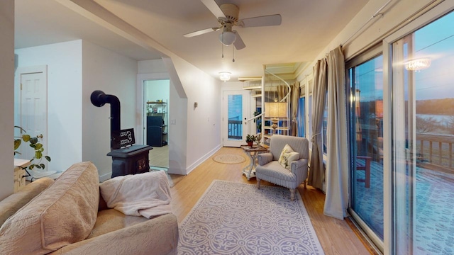 living room featuring light hardwood / wood-style floors and ceiling fan