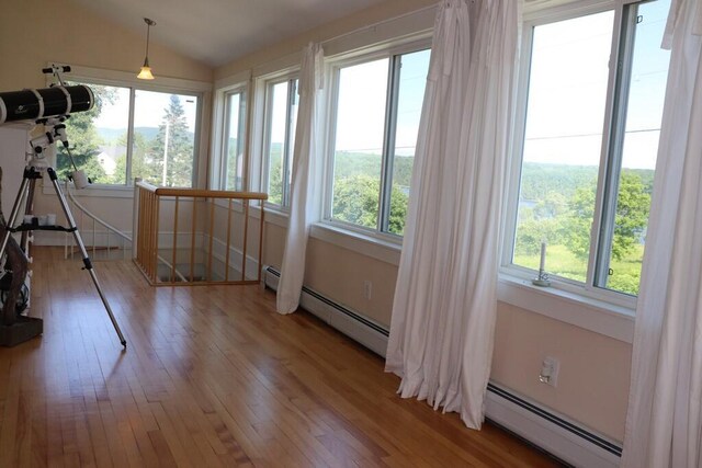 sunroom / solarium with baseboard heating and lofted ceiling