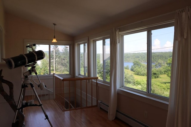 unfurnished sunroom with a wealth of natural light, baseboard heating, and lofted ceiling