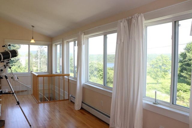 sunroom with a baseboard radiator and lofted ceiling