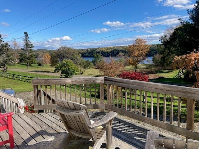 deck featuring a yard and a water view