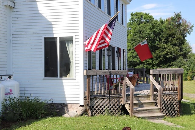 view of property exterior with a wooden deck