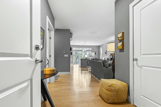 hallway with light hardwood / wood-style flooring