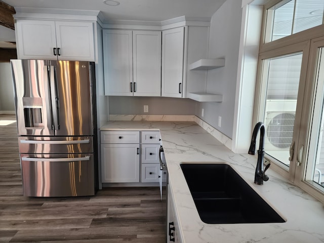61 Hathaway Hill Rd, Livermore, ME 04253 - kitchen with stainless steel refrigerator with ice dispenser, open shelves, a sink, white cabinets, and light stone counters