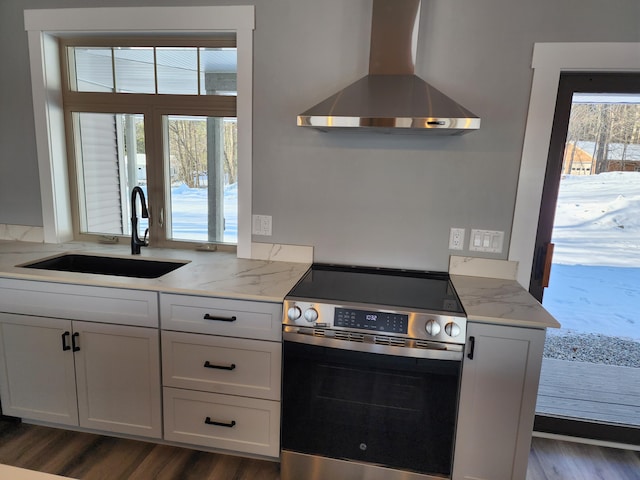 61 Hathaway Hill Rd, Livermore, ME 04253 - kitchen featuring wall chimney range hood, stainless steel electric range oven, a sink, and dark wood finished floors