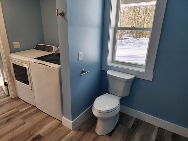 61 Hathaway Hill Rd, Livermore, ME 04253 - bathroom with separate washer and dryer, baseboards, toilet, and wood finished floors