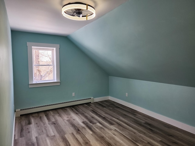 61 Hathaway Hill Rd, Livermore, ME 04253 - bonus room featuring baseboard heating, vaulted ceiling, dark wood finished floors, and baseboards