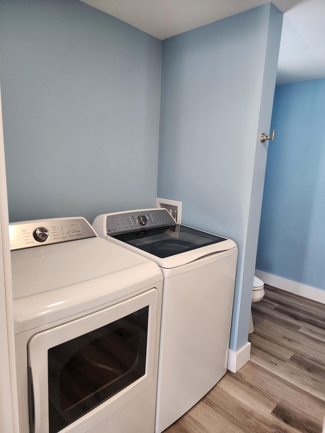 61 Hathaway Hill Rd, Livermore, ME 04253 - laundry room with washing machine and dryer, wood finished floors, and baseboards