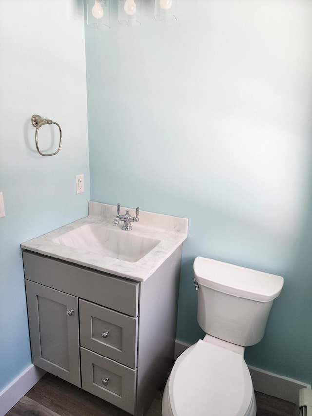 61 Hathaway Hill Rd, Livermore, ME 04253 - bathroom featuring vanity, toilet, wood finished floors, and baseboards