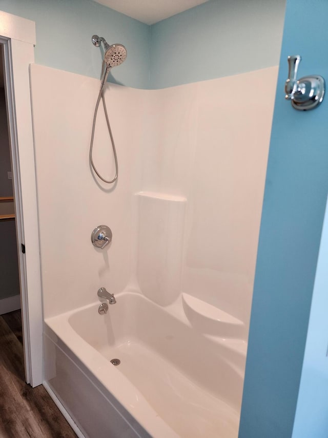 61 Hathaway Hill Rd, Livermore, ME 04253 - full bathroom with wood finished floors and tub / shower combination