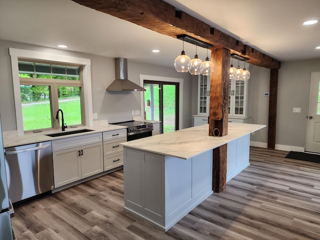 61 Hathaway Hill Rd, Livermore, ME 04253 - kitchen with wall chimney exhaust hood, appliances with stainless steel finishes, a sink, dark wood-style floors, and light stone countertops