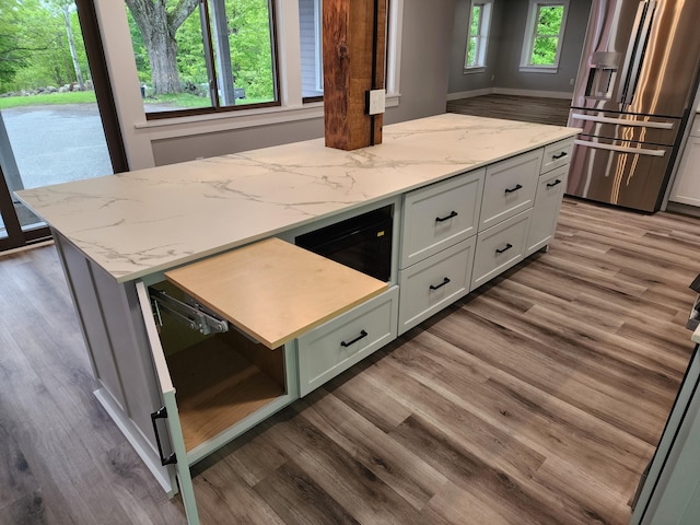 61 Hathaway Hill Rd, Livermore, ME 04253 - kitchen featuring stainless steel fridge with ice dispenser, wood finished floors, a kitchen island, and light stone countertops