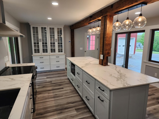 61 Hathaway Hill Rd, Livermore, ME 04253 - kitchen with wall chimney range hood, black microwave, dark wood-style flooring, recessed lighting, and glass insert cabinets