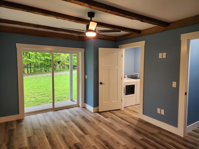 61 Hathaway Hill Rd, Livermore, ME 04253 - unfurnished room featuring washer and dryer, baseboards, beamed ceiling, a ceiling fan, and wood finished floors