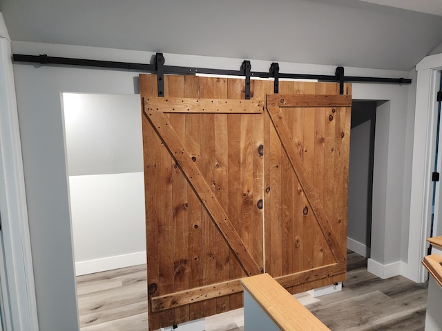 61 Hathaway Hill Rd, Livermore, ME 04253 - detailed view of a barn door, wood finished floors, and baseboards