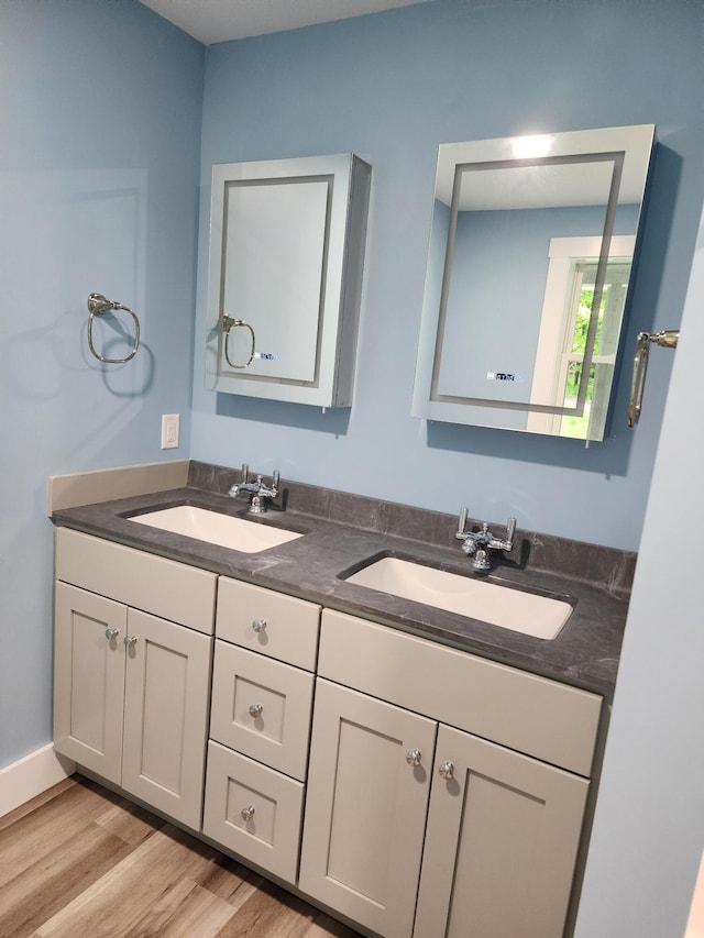 61 Hathaway Hill Rd, Livermore, ME 04253 - full bath featuring double vanity and wood finished floors
