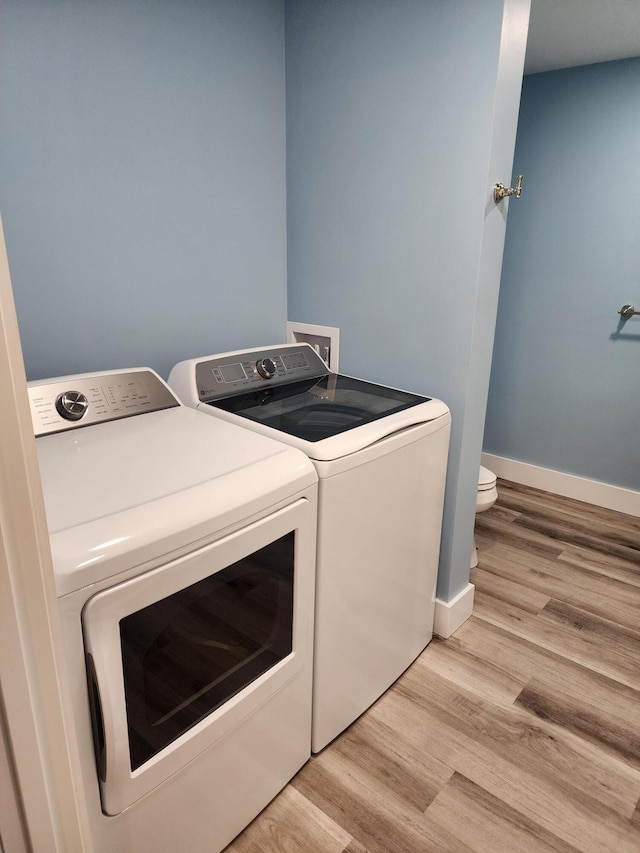 61 Hathaway Hill Rd, Livermore, ME 04253 - laundry area featuring washer and clothes dryer, light wood-style flooring, and baseboards