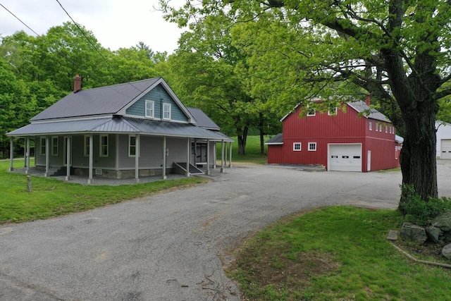 61 Hathaway Hill Rd, Livermore, ME 04253 - view of front of home with driveway, an outbuilding, a detached garage, and a front lawn