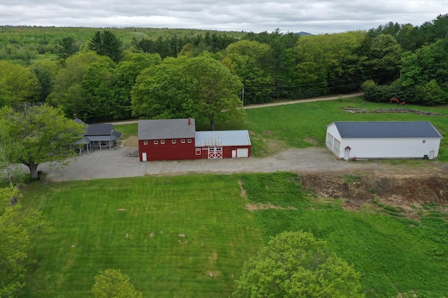 61 Hathaway Hill Rd, Livermore, ME 04253 - view of grassy yard featuring a forest view, a pole building, and an outdoor structure