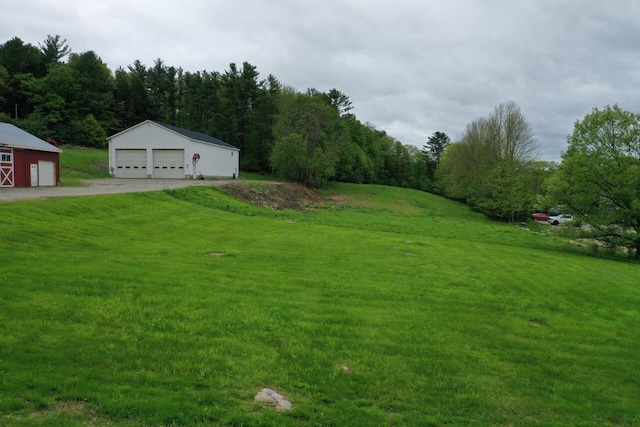 61 Hathaway Hill Rd, Livermore, ME 04253 - view of green lawn with a garage and an outbuilding