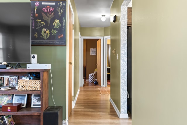 corridor with light hardwood / wood-style flooring