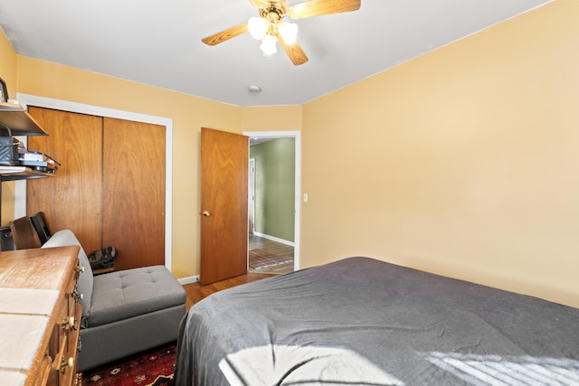 bedroom with ceiling fan, light hardwood / wood-style flooring, and a closet