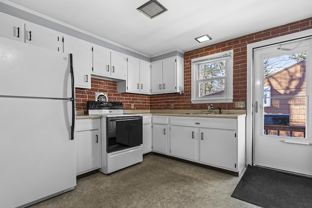 kitchen with sink, white cabinetry, range with electric stovetop, and white fridge