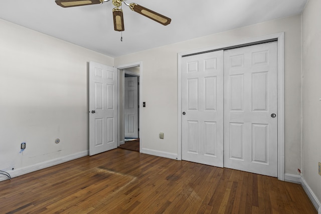 unfurnished bedroom with ceiling fan, a closet, and dark hardwood / wood-style floors