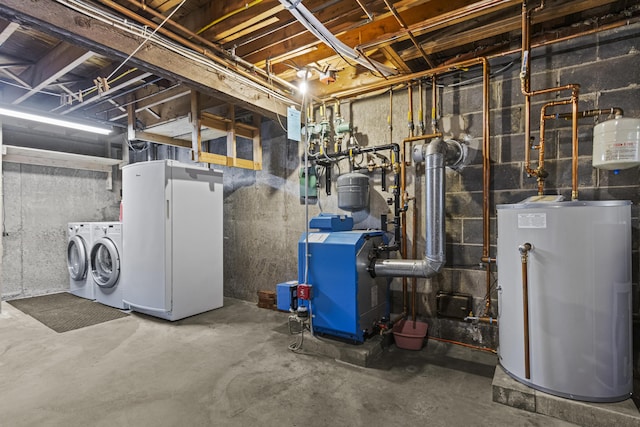 basement with washer and clothes dryer, white fridge, and gas water heater