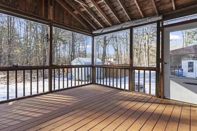 unfurnished sunroom featuring wooden ceiling and lofted ceiling