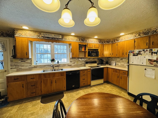 kitchen with black appliances, hanging light fixtures, tasteful backsplash, and sink