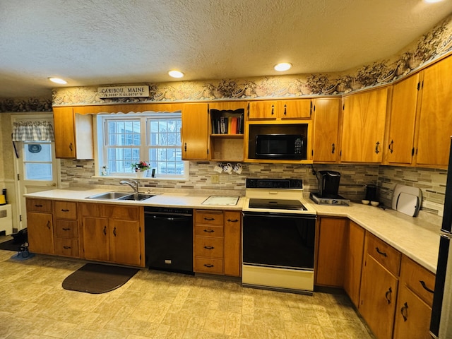 kitchen featuring sink, black appliances, a textured ceiling, and tasteful backsplash