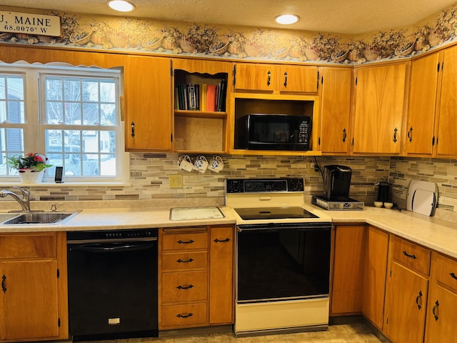 kitchen featuring black appliances, a textured ceiling, tasteful backsplash, and sink