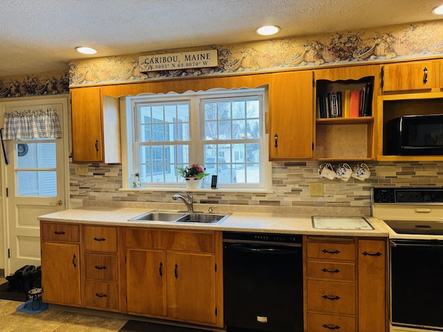 kitchen featuring black appliances, a textured ceiling, and sink