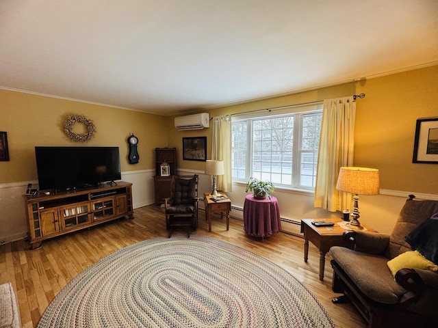 sitting room featuring a baseboard radiator, wood-type flooring, and a wall unit AC