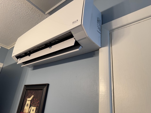 interior details featuring a wall mounted air conditioner and ornamental molding