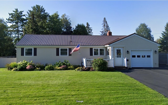 ranch-style home featuring a garage, cooling unit, and a front yard