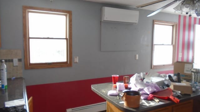 interior space featuring ceiling fan, a wall mounted AC, and a baseboard radiator