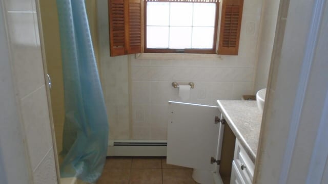 bathroom featuring baseboard heating, tile patterned flooring, a shower with curtain, and vanity