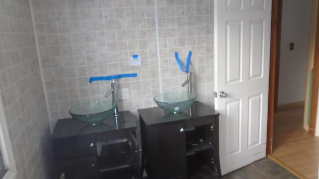 bathroom with tile walls, tile patterned floors, and vanity