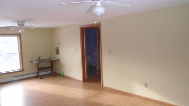 unfurnished room featuring ceiling fan and light hardwood / wood-style flooring