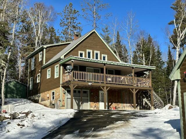 view of front of property featuring a garage and a wooden deck