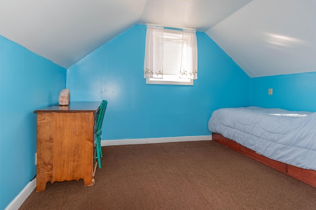 carpeted bedroom with lofted ceiling