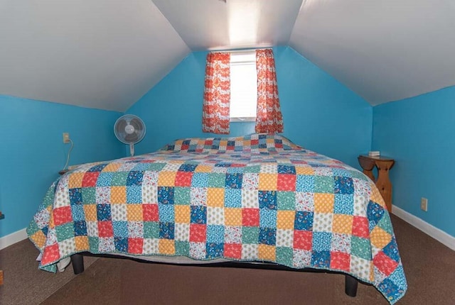 bedroom with lofted ceiling and carpet floors