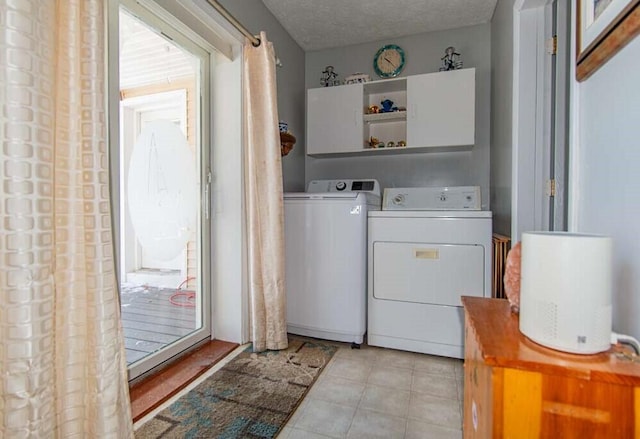 laundry room with washing machine and dryer and a textured ceiling