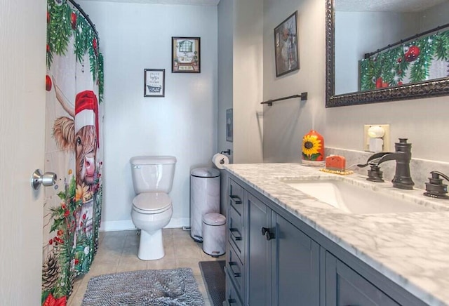 bathroom featuring toilet, tile patterned floors, and vanity