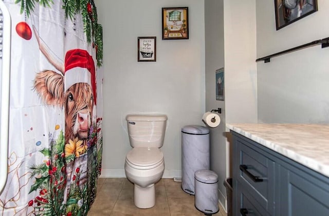 bathroom with toilet, tile patterned flooring, and vanity