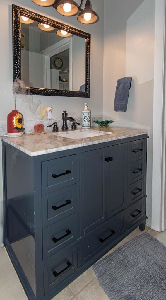 bathroom featuring tile patterned flooring and vanity