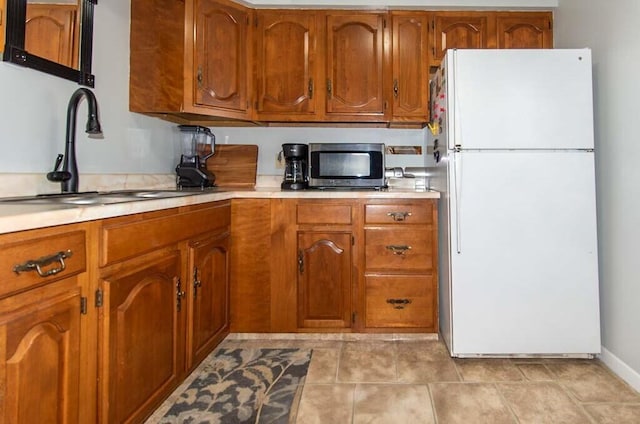 kitchen featuring sink and white fridge